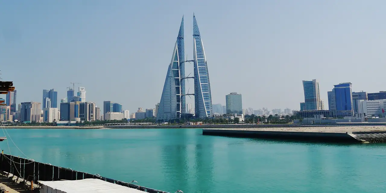 Bahrain World Trade Center and the Manama skyline across turquoise water